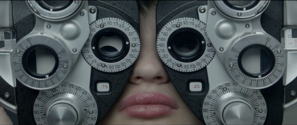 The race against time starts after this visit to the optometrist. Photo still from movie.