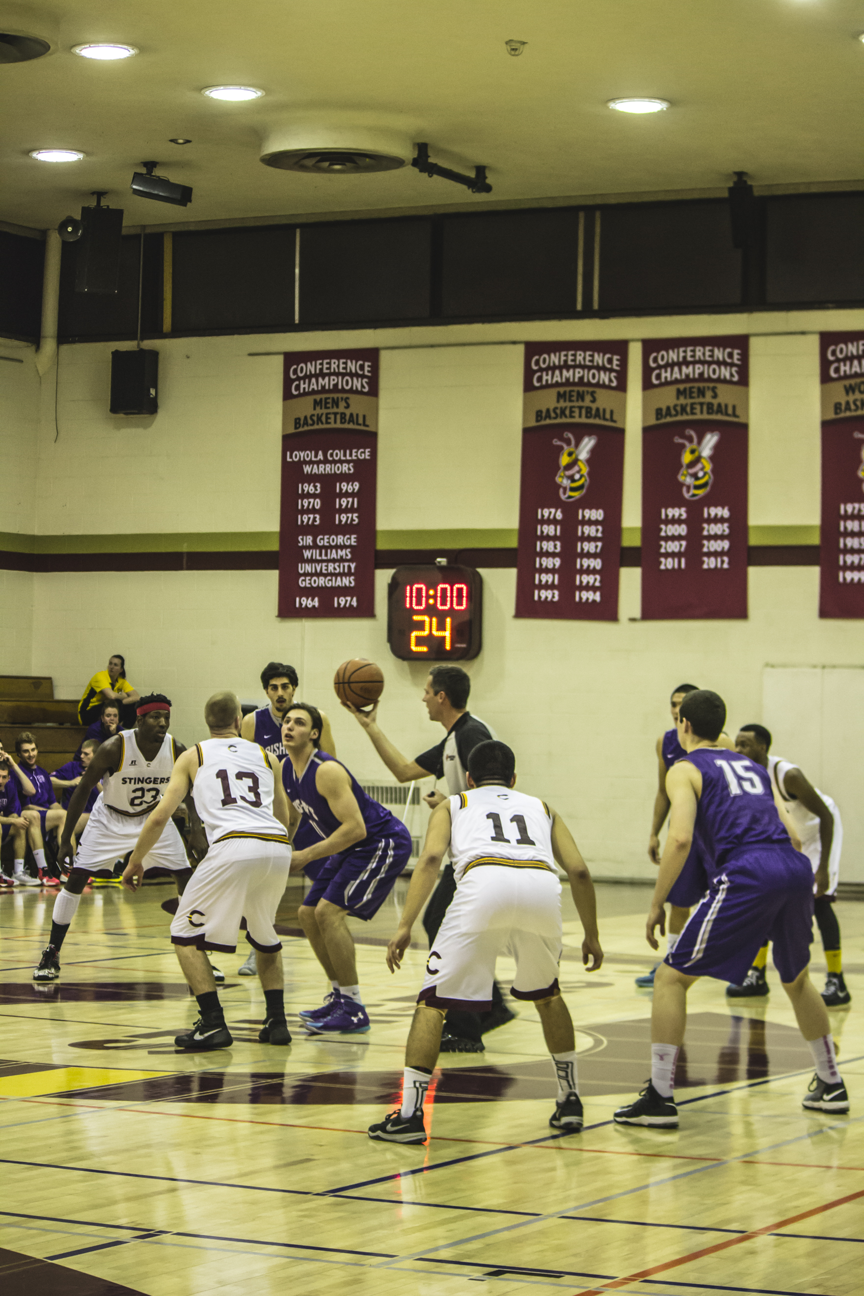The Stingers men’s basketball team goes for the ball off of the opening jump ball. Photos by Melissa Martella.