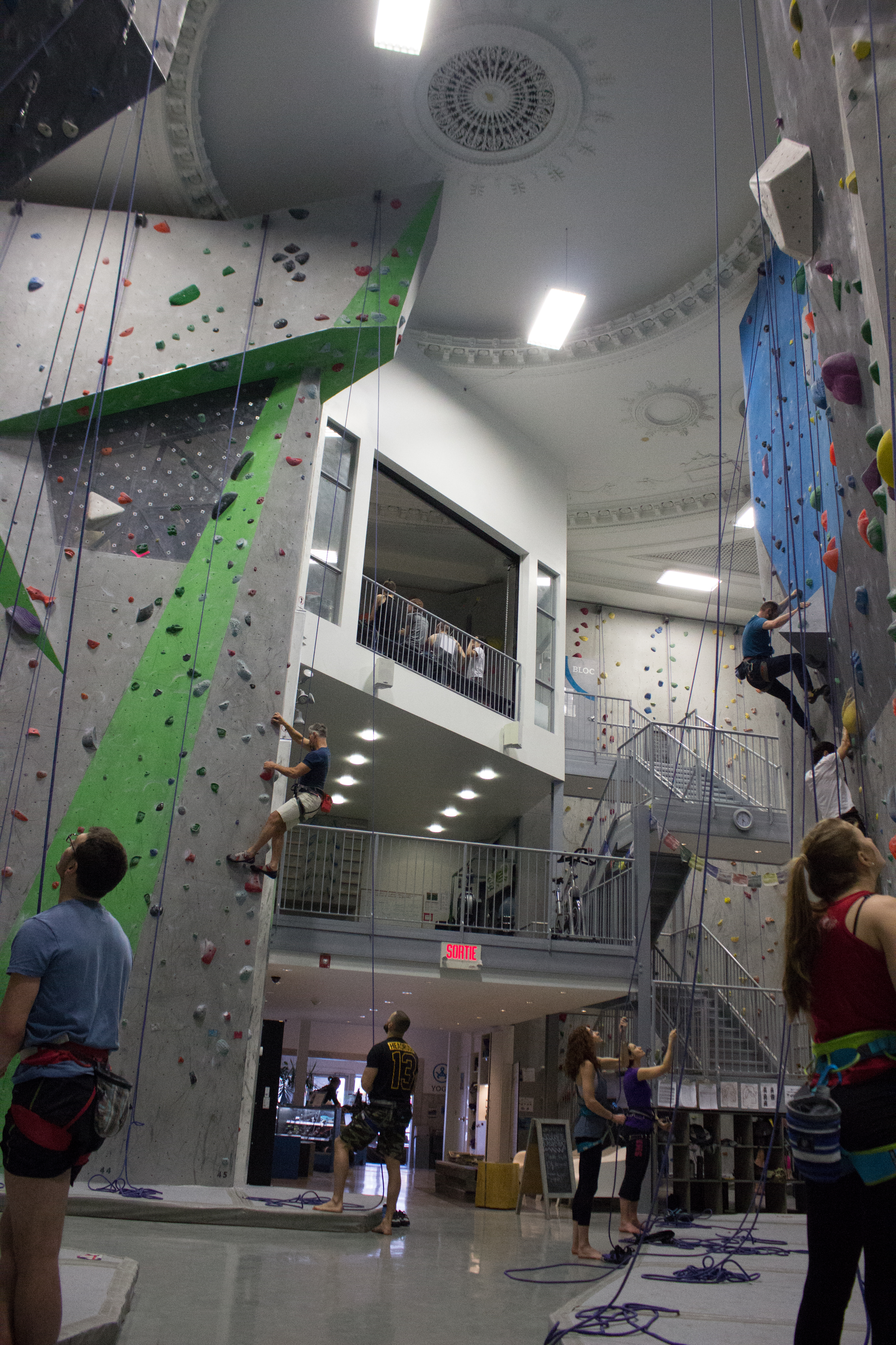 Anxious rock-climbers look up and get ready to climb the wall. Photos by Melissa Martella.