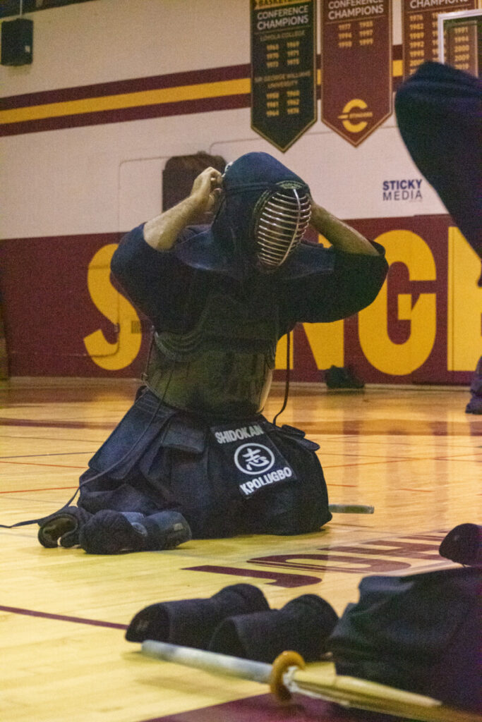 Kendo Instructor instructing students on how to properly prepare their sparing armour. (Photo by Lucas Marsh)